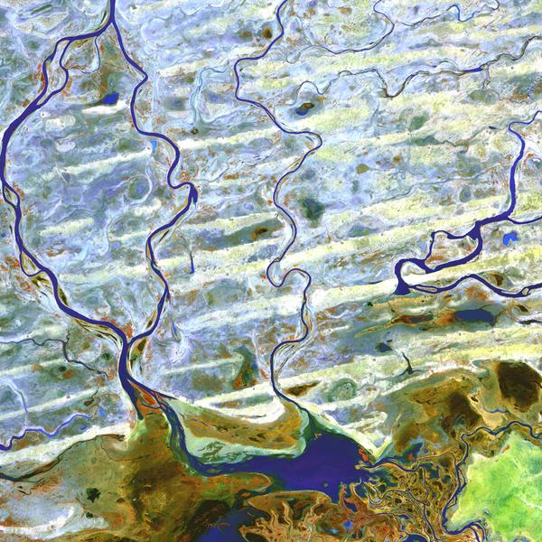 Aerial photo of the River Niger in Mali, showing branches of the river and the landscape in bands of translucent colors.